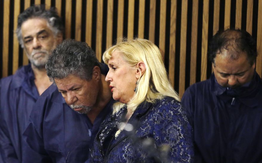 ** FILE ** Defense attorney Kathleen DeMetz, second from right, talks with Pedro Castro as Onil Castro, left, watches and Ariel Castro, right, looks down, in Cleveland Municipal court Thursday, May 9, 2013, in Cleveland. Ariel Castro was charged with four counts of kidnapping and three counts of rape. Pedro Castro pleaded no contest to an unrelated open-container charge in court Monday. Two unrelated misdemeanor charges against Onil Castro were dropped. Police announced on Thursday afternoon that 54-year-old Pedro Castro and 50-year-old Onil Castro had been released from jail. (AP Photo/Tony Dejak)