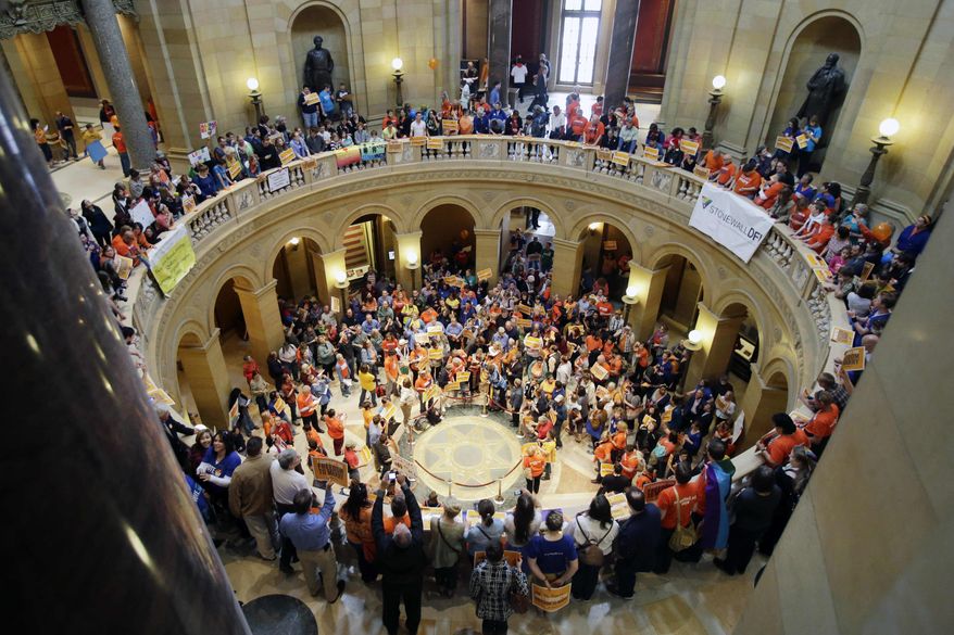 Supporters and opponents of Minnesota's gay marriage bill gather in the State Capitol Rotunda in St. Paul as the Senate prepared to take up the issue, Monday, May 13, 2013 in St. Paul, Minn. The bill passed the Minnesota House last week. (AP Photo/Jim Mone)