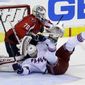 New York Rangers left wing Rick Nash (61) slides into Washington Capitals goalie Braden Holtby (70) in overtime of Game 5 first-round NHL Stanley Cup playoff hockey series, Friday, May 10, 2013 in Washington. The Capitals won 2-1, in overtime. (AP Photo/Alex Brandon)