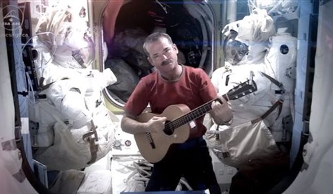 Astronaut Chris Hadfield recording the first music video from space Sunday May 12, 2013. The song was his cover version of David Bowie&#x27;s Space Oddity. (AP Photo/NASA, Chris Hadfield)