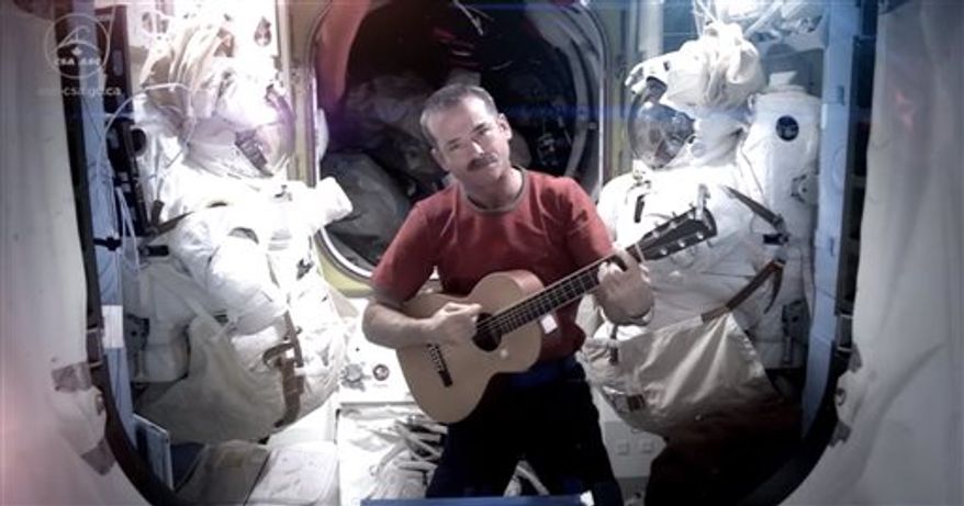 Astronaut Chris Hadfield recording the first music video from space Sunday May 12, 2013. The song was his cover version of David Bowie's Space Oddity. (AP Photo/NASA, Chris Hadfield)