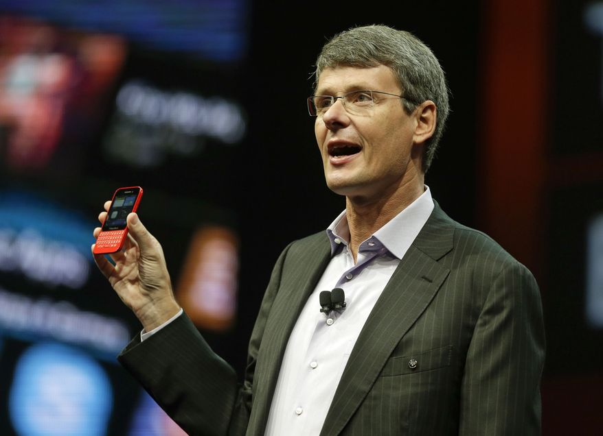 Thorsten Heins, president and CEO of Research In Motion, holds up the new BlackBerry 10 mobile device at the company's annual conference on Tuesday, May 14, 2013, in Orlando, Fla. (AP Photo/John Raoux)