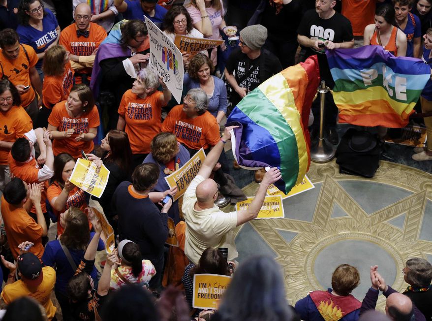Thousands filled the Minnesota State Capitol as they waited for word that the Senate had passed the gay marriage bill Monday, May 13, 2013, in St. Paul, Minn. The governor has now signed the bill into law. (AP Photo/Jim Mone) **FILE**
