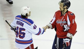 Washington Capitals left wing Alex Ovechkin (8), from Russia, shakes hands with New York Rangers right wing Arron Asham (45) after a Game 7 first-round NHL Stanley Cup playoff hockey series, Monday, May 13, 2013, in Washington. The Rangers won 5-0. (AP Photo/Nick Wass)