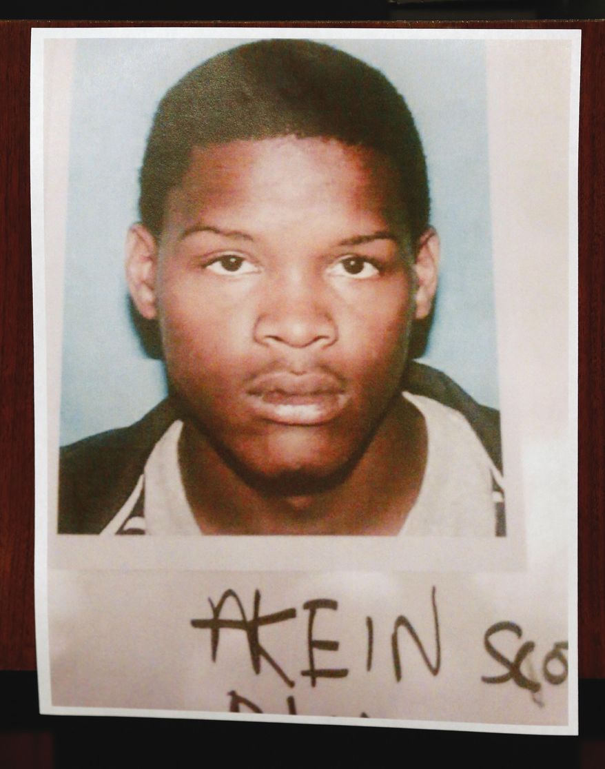 New Orleans Police Superintendent Ronal Serpas (not shown) presents a photo of 19-year-old Akien Scott who is wanted in the Mother's Day shootings during a news conference in front of police headquarters in New Orleans, Monday, May 13, 2013. (AP Photo/Bill Haber)