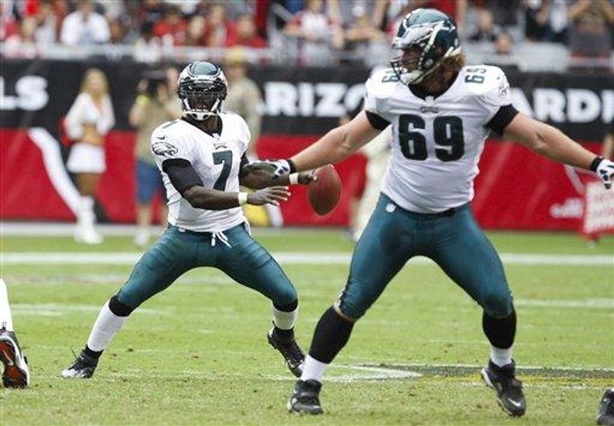 Philadelphia Eagles&#39; Michael Vick (7) looks for an open receiver as Evan Mathis (69) protects the quarterback against the Arizona Cardinals during the second half in an NFL football game Sunday, Sept. 23, 2012, in Glendale, Ariz. The Cardinals defeated the Eagles 27-6.(AP Photo/Rick Scuteri)