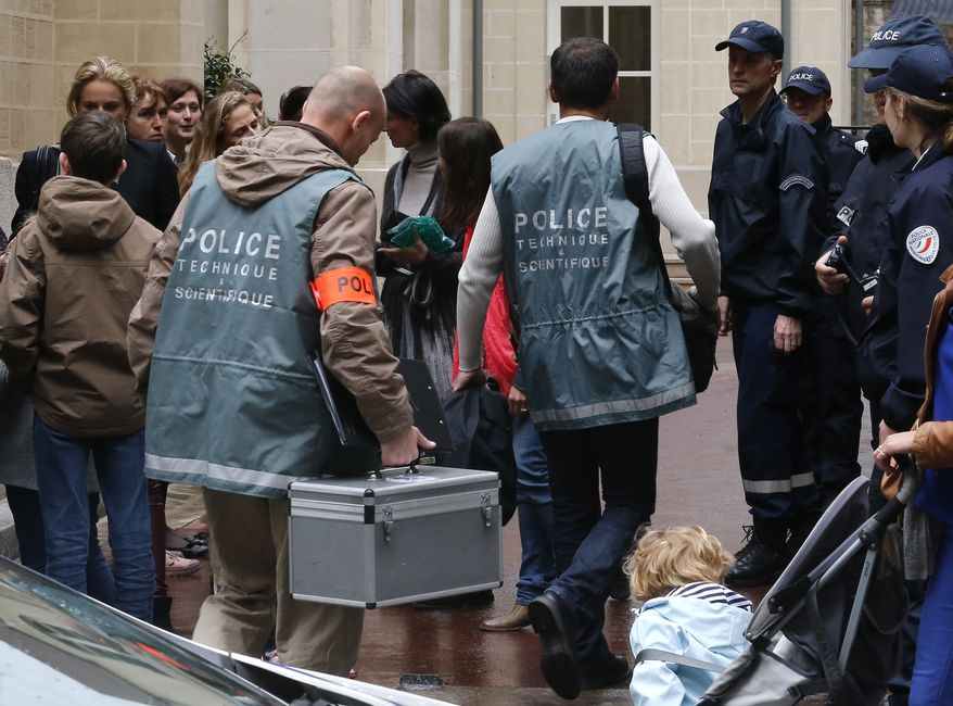 Police forensics officers arrive at the La Rochefoucauld school on Thursday, May 16, 2013, in Paris after a man committed suicide at the private Catholic institution by shooting himself in the head. (AP Photo/Jacques Brinon)