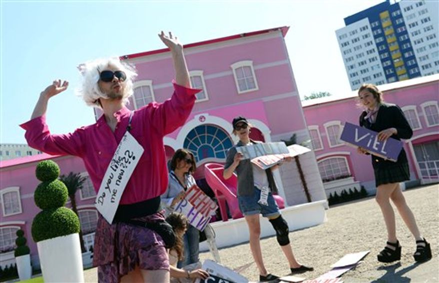 Demonstrators protest in front of the Barbie Dream House in Berlin Thursday, May 16, 2013. (AP Photo/dpa, Jens Kalaene)