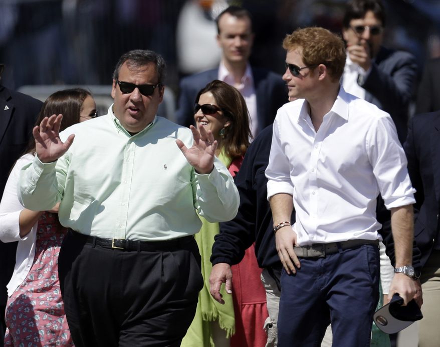 Britain's Prince Harry, right, walks with New Jersey Gov. Chris Christie at Casino Pier during a tour of the area hit by Superstorm Sandy, Tuesday, May 14, 2013, in Seaside Heights, N.J. The prince toured the community's rebuilt boardwalk, which is about two-thirds complete. New Jersey sustained about $37 billion worth of damage from the storm. (AP Photo/Julio Cortez)