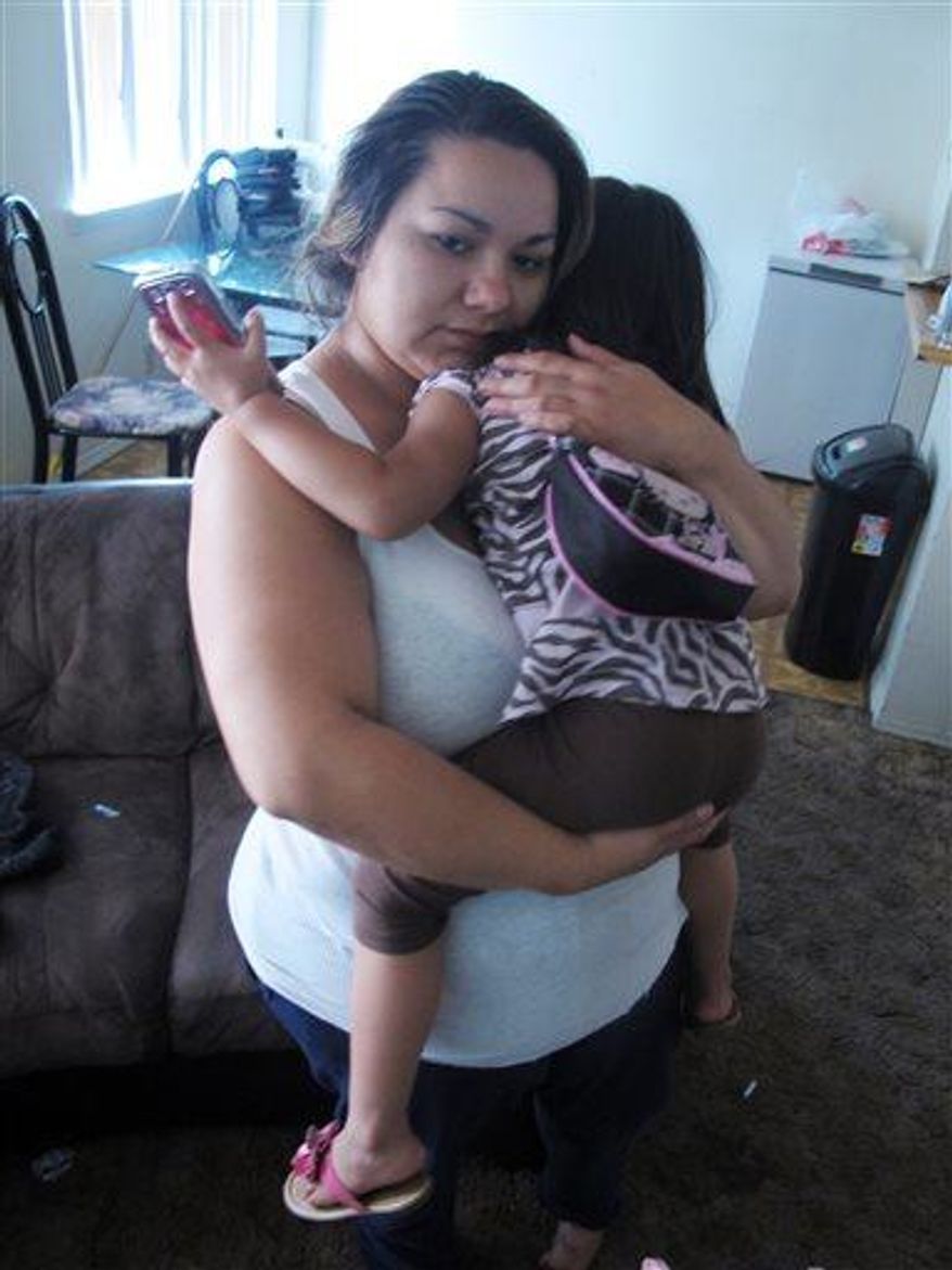 Melissa Torrez, 27, holds her 4-year-old daughter in her apartment in Albuquerque, N.M., Friday, May 17, 2013. Torrez chased down a man for miles and ran into his car Wednesday, May 15, after he abducted her daughter. She told The Associated Press her “mother's instincts” kicked in when she launched her chase. (Associated Press)