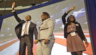 E.W. Jackson, with his wife Theodora (center) and daughter Jacquelyn (right), as he prepares to accept the GOP nomination for lieutenant governor of Virginia in Richmond in May, 2013. (AP Photo/Steve Helber)
