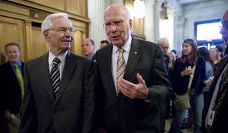 **FILE** Sens. Patrick Leahy (right), Vermont Democrat and president pro tempore of the Senate, and Thad Cochran, Mississippi Republican, walk to the floor of the Senate on Capitol Hill on May 6, 2013, during a vote on legislation to collect sales tax on Internet purchases. (Associated Press)