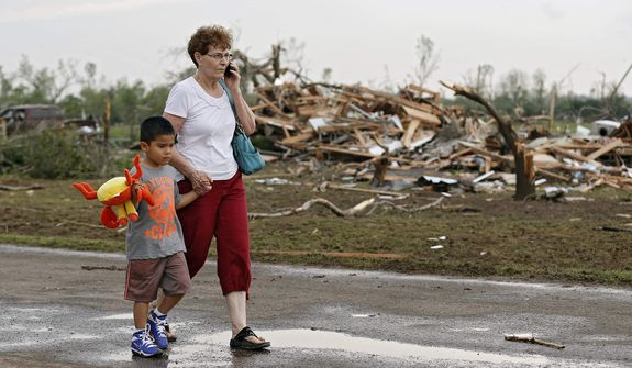 Chole Findley walks with her grandson Mark Williams as they leave the area where their home was destroyed after the tornado hit the area near 149th and Drexel on Monday, May 20, 2013 in Oklahoma City, Okla. (AP Photo/ The Oklahoman, Chris Landsberger)