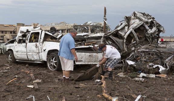Two men go through the damage surrounding the Moore Medical Center after a tornado moves through Moore, Okla., on Monday, May 20, 2013. (AP Photo/Alonzo Adams)