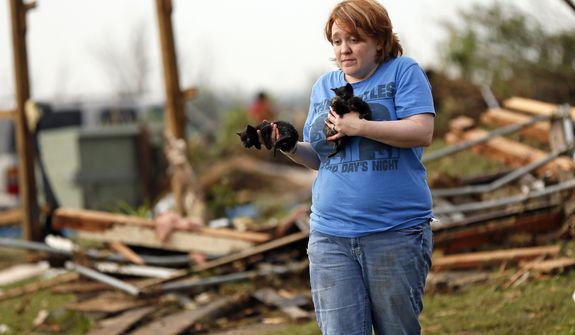 Rachel Hilton holds stray kittens she found in the debris of her parents&#39; home at SW 149th and Stone Meadows Drive after a tornado struck south Oklahoma City and Moore, Okla., Monday, May 20, 2013. (AP Photo/The Oklahoman, Nate Billings)