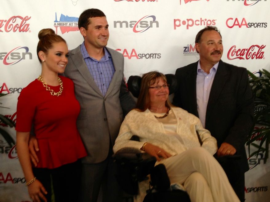 Nationals third baseman Ryan Zimmerman, second from left, along with his wife Heather, left, and parents Cheryl and Keith, posed at the start of Zimmerman's annual "A Night at the Park" fundraiser at Nationals Park on Thursday. Cheryl Zimmerman has Multiple Sclerosis and Ryan Zimmerman's ziMS Foundation works to raise money to help find a cure for this disease. (Staff photo)
