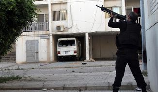 ** FILE ** A Sunni gunman fires his machine gun during clashes that erupted between pro- and anti-Syrian regime gunmen, in the northern port city of Tripoli, Lebanon, Thursday, May. 23, 2013. (AP Photo)