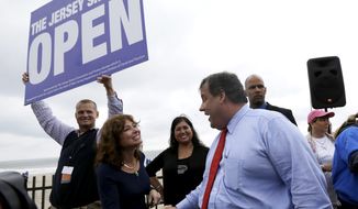 ** FILE ** New Jersey Gov. Chris Christie, right, talks to Carla Pilla, of Seaside Heights, N.J., while Robert Hilton, left, executive director of the Jersey Shore Convention and Visitor&#39;s Bureau, holds a sign, Friday, May 24, 2013, in Seaside Heights, N.J. Christie cut a ribbon to symbolically reopen the state&#39;s shore for the summer season, seven months after being devastated by Superstorm Sandy. (AP Photo/Julio Cortez)