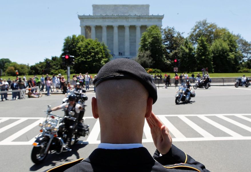 Flags and salutes were the order of the day Sunday as miles of motorcycles crossed Memorial Bridge en route to the Mall in the 26th annual Rolling Thunder Ride for Freedom. (Associated Press)