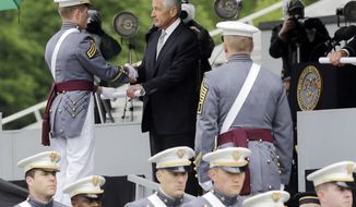 Defense Secretary Chuck Hagel (center) hands diplomas to cadets during graduation and commissioning ceremonies at the U.S. Military Academy in West Point, N.Y., on Saturday, May 25, 2013. (AP Photo/Mike Groll)