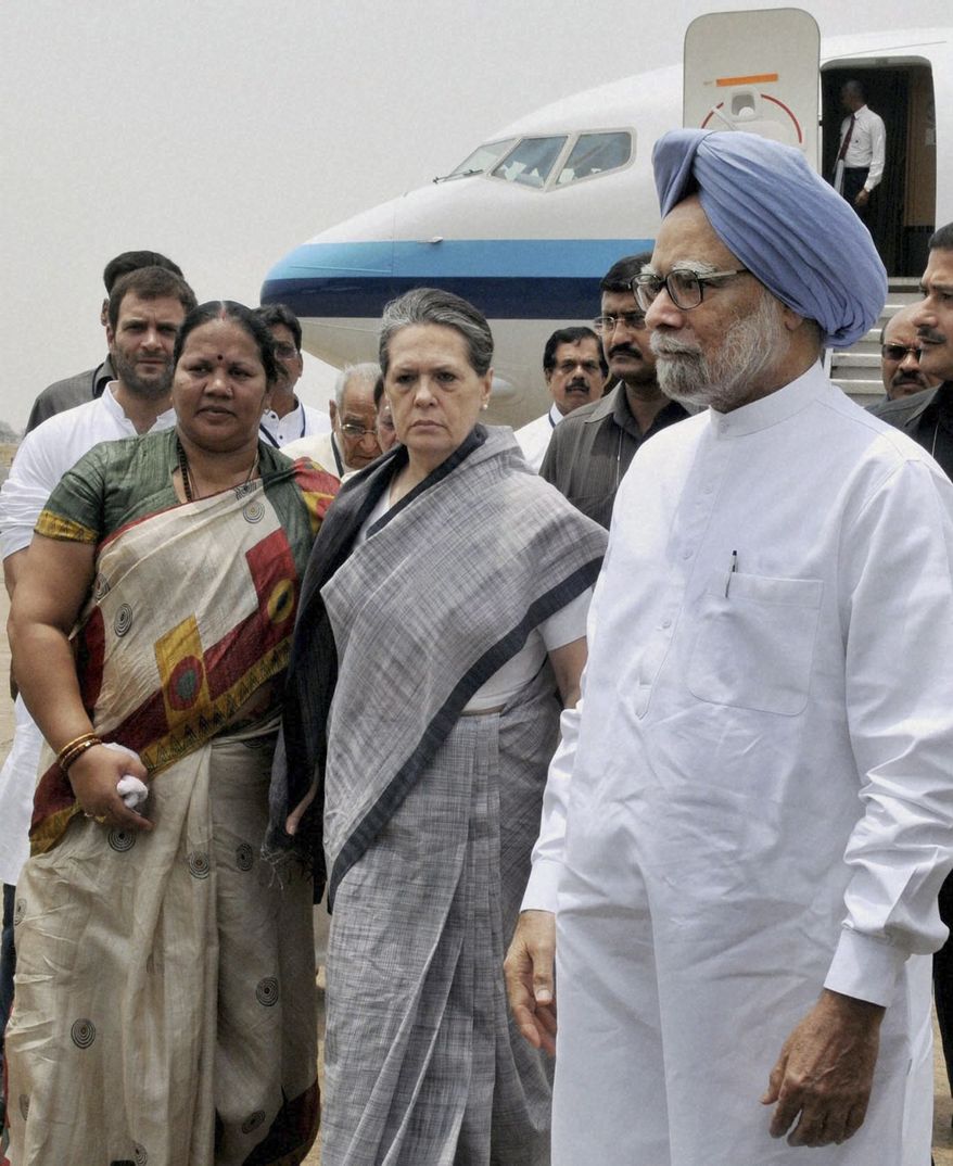 Indian Prime Minister Manmohan Singh (front right), Congress party President Sonia Gandhi (center) and party Vice President Rahul Gandhi (background left) arrive at the airport in Raipur, India, on Sunday, May 26, 2013, following Saturday's Maoist attack in a densely forested area in India's Chhattisgarh state. (AP Photo)