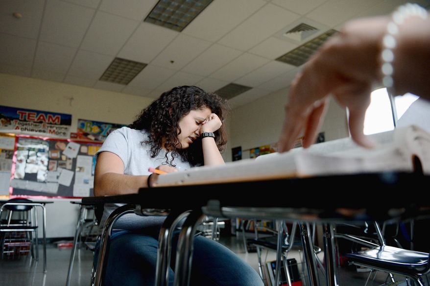 Alicia Gonzalez, 14, works with her spelling coach and teacher Shelley Daisley, in Winchester, Va., in preparation for this week's Scripps National Spelling Bee.