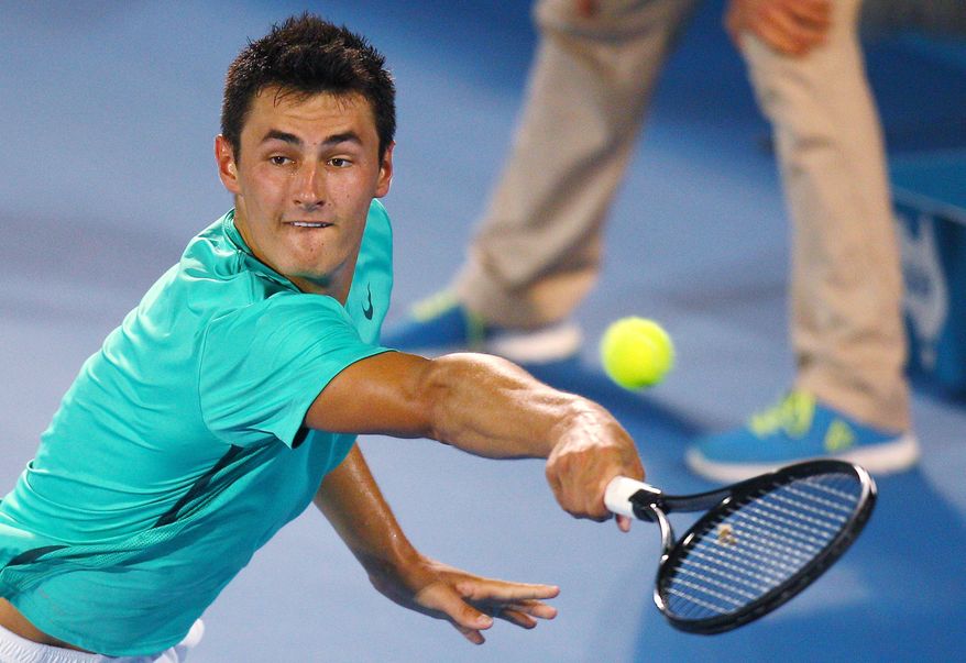 FILE - In this Saturday, Jan. 12, 2013 file photo Australia's Bernard Tomic plays a shot to Kevin Anderson of South Africa during the men's final at the Sydney International tennis tournament in Sydney, Australia. Bernard Tomic's hitting partner Thomas Drouet has called for the father of the Australian tennis player to be banned after he was allegedly assaulted on Saturday May 4, 2013. John Tomic has been charged with assault after allegedly headbutting Drouet ahead of this week's Madrid Open. (AP Photo/Rick Rycroft, File)