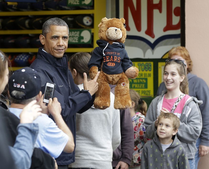 President Obama holds up a stuffed bear that New Jersey Gov. Chris Christie (not shown) had won tossing a football after playing the "Touchdown Fever" game on the boardwalk during their visit to Point Pleasant, N.J., on May 28, 2013. Obama traveled to New Jersey to join Christie to inspect and tour the Jersey Shore's recovery efforts from Hurricane Sandy. (Associated Press)
