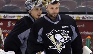 Pittsburgh Penguins goaltenders Marc-Andre Fleury,left, and Tomas Vokoun practice in Ottawa, Ontario, Saturday, May 18, 2013, on the eve of Game 3 of the NHL hockey Stanley Cup playoff series against the Ottawa Senators. (AP Photo/The Canadian Press, Fred Chartrand)