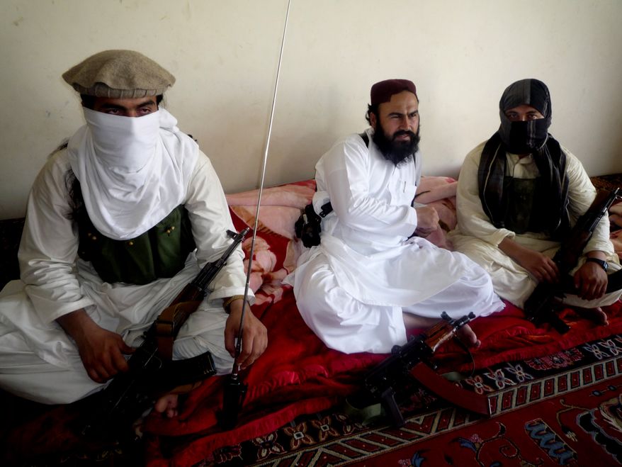 ** FILE ** Waliur Rehman (center), the Pakistani Taliban's No. 2 leader, talks with The Associated Press during an interview in Shawal area of South Waziristan along the Afghanistan border in Pakistan on July 28, 2011. (AP Photo/Ishtiaq Mahsud)