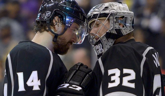 Los Angeles Kings right wing Justin Williams, left, greets goalie Jonathan Quick after their 2-1 win against the San Jose Sharks in Game 7 of the Western Conference semifinals in the NHL hockey Stanley Cup playoffs, Tuesday, May 28, 2013, in Los Angeles. (AP Photo/Mark J. Terrill)