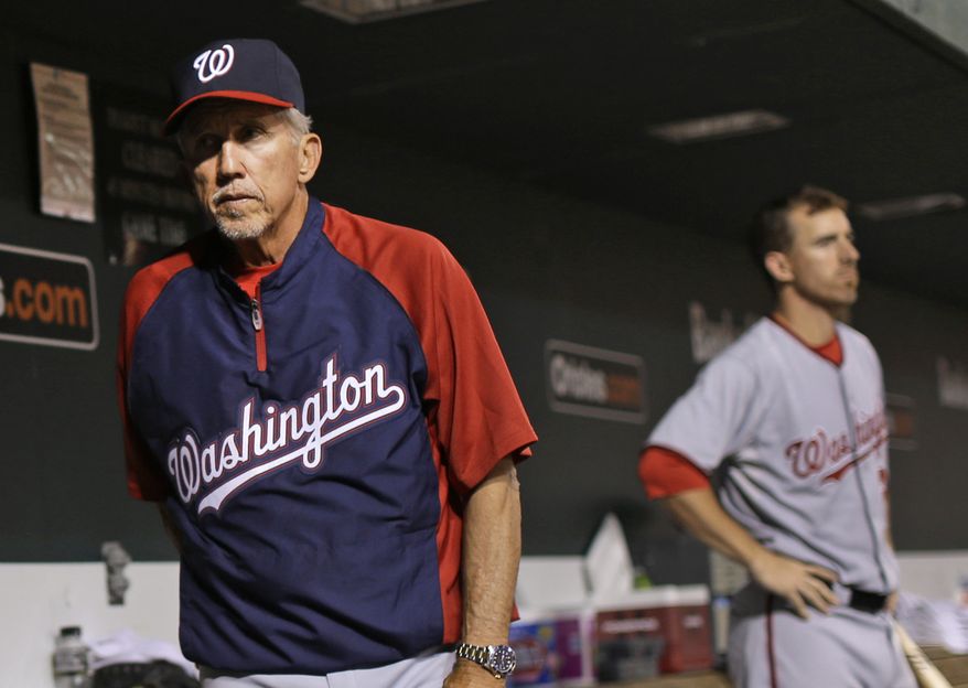 The Washington Nationals fell to .500 Thursday night after a 2-0 loss to the Baltimore Orioles. Davey Johnson, left, and Adam LaRoche, right, look on during the game. (Associated Press photo)