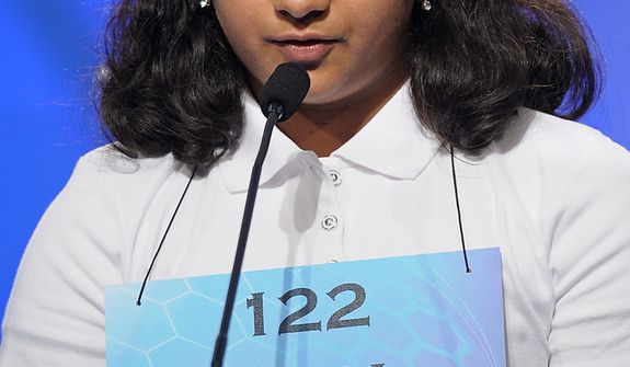 Neha Seshadri, 12, of Imlay City, Mich., spells &quot;physiognomy&quot; during the semifinal round of the Scripps National Spelling Bee in Oxon Hill, Md., Thursday, May 30, 2013. (AP Photo/Cliff Owen)