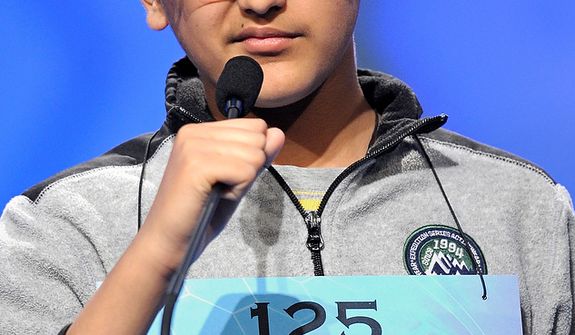 Kuvam Shahane, 13, of Rochester Hills, Mich., spells &quot;griseous&quot; during the semifinal round of the Scripps National Spelling Bee in Oxon Hill, Md., Thursday, May 30, 2013. (AP Photo/Cliff Owen)