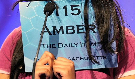 Amber Born, 14 of Marblehead, Mass., covers her face while spelling &quot;malacophilous&quot; during the semifinal round of the Scripps National Spelling Bee in Oxon Hill, Md., Thursday, May 30, 2013. (AP Photo/Cliff Owen)  