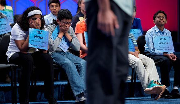Neha Seshadri, 12, of Imlay City, Mich., left, Kuvam Shahane, 13, of Rochester Hills, Mich., center, and Ryan Devanandan, 13, of Albany, N.Y., right, listen as Anuk Dayaprema, 14, of Vincenza, Italy spells during the semifinal round of the National Spelling Bee, Thursday, May 30, 2013, in Oxon Hill, Md. (AP Photo/Evan Vucci) 
