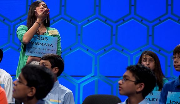 Vismaya Kharkar, 14, of Bountiful, Utah blows a kiss to her family during a break in the semifinal round of the National Spelling Bee, Thursday, May 30, 2013, in Oxon Hill, Md. (AP Photo/Evan Vucci) 