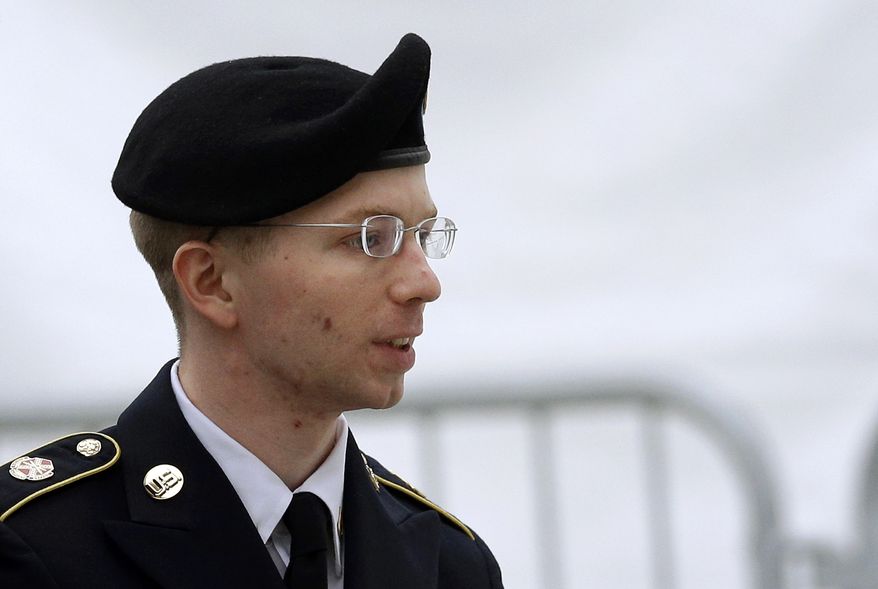 ** FILE ** Army Pfc. Bradley Manning is escorted into a courthouse at Fort Meade, Md., before a pretrial military hearing on Tuesday, May 21, 2013. (AP Photo/Patrick Semansky)