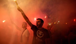 Protesters light flares and shout slogans during a protest at Taksim Square in Istanbul, on Tuesday. Thousands have joined anti-government rallies across since Friday, when police launched a pre-dawn raid against a sit-in protesting plans to uproot trees in the square. Since then, the demonstrations have spiraled into Turkey&#39;s biggest anti-government disturbances in years. (Associated Press)