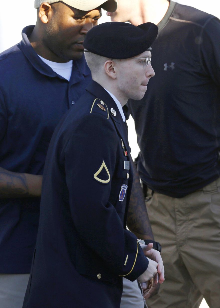 Army Pfc. Bradley Manning is escorted into a courthouse at Fort Meade, Md., on Tuesday, June 4, 2013, before the second day of his court-martial. Pfc. Manning is charged with indirectly aiding the enemy by sending troves of classified material to WikiLeaks. He faces up to life in prison. (AP Photo/Patrick Semansky)