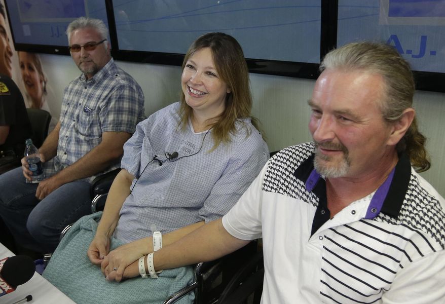 Jim Gerber, left, looks on as Lynette Hales and her husband Jeff Hales, right, speak with reporters following a news conference at the Intermountain Medical Center Monday, June 3, 2013, in Murray, Utah. Lynette Hales was nearly 100 miles from Salt Lake City on a rural stretch of highway surrounded by nothing but barren salt flats when her twin unborn babies decided it was time. (AP Photo/Rick Bowmer)