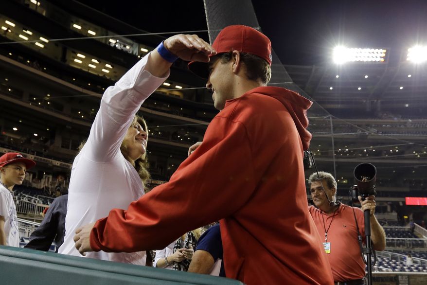 Tambra Kams, left, from Arlington, Texas, hugs her son Washington Nationals starting pitcher Nathan Karns, after his first major league start, after an interleague baseball game against the Baltimore Orioles at Nationals Park Tuesday, May 28, 2013, in Washington. The Nationals won 9-3. (AP Photo/Alex Brandon)