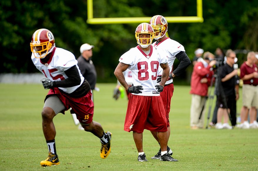 Washington Redskins wide receiver Santana Moss (89), center, watches drills during a NFL football organized team activity at Redskins Park, Ashburn, Va., Thursday, June 6, 2013. (Andrew Harnik/The Washington Times)