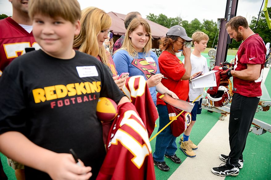 Washington Redskins strong safety Reed Doughty (37) signs autographs following a NFL football organized team activity at Redskins Park, Ashburn, Va., Thursday, June 6, 2013. (Andrew Harnik/The Washington Times)