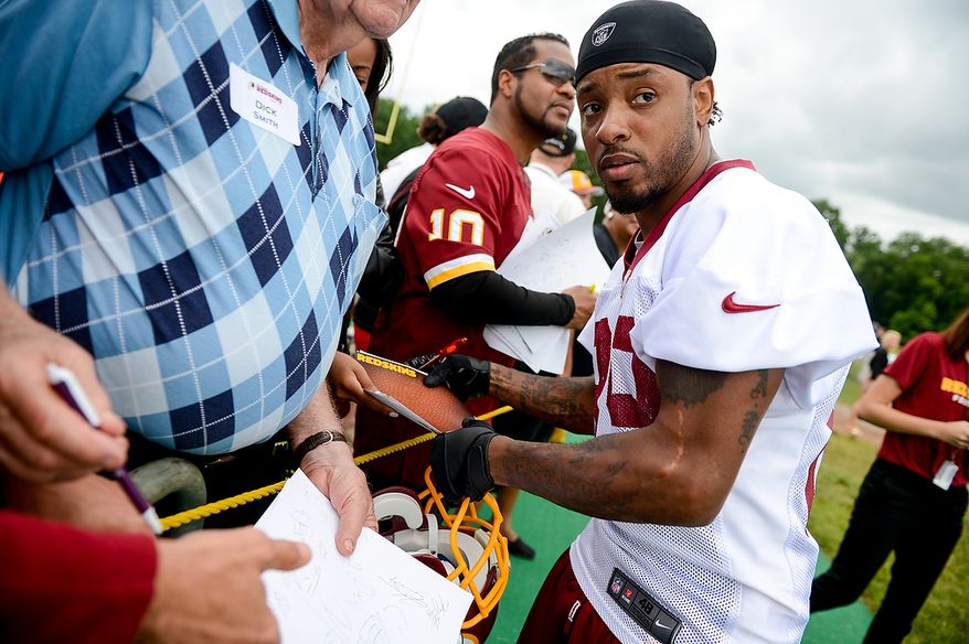 Washington Redskins wide receiver Santana Moss (89) signs autographs following a NFL football organized team activity at Redskins Park, Ashburn, Va., Thursday, June 6, 2013. (Andrew Harnik/The Washington Times)