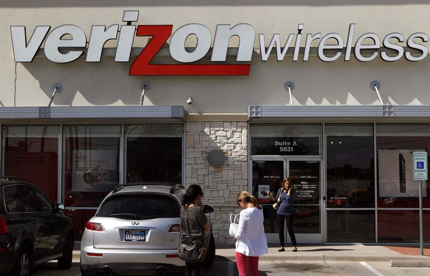 ** FILE ** Customers walk into a Verizon Wireless store in Dallas on Wednesday, Oct. 17, 2012. (AP Photo/LM Otero)