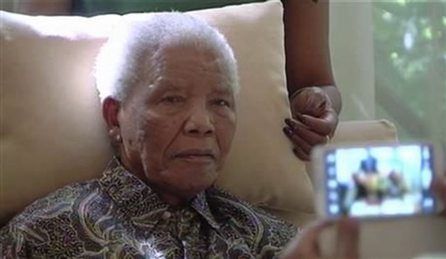 ** FILE ** The ailing anti-apartheid icon Nelson Madela is filmed on Monday, April 29, 2013, more than three weeks after being released from hospital. (Associated Press)