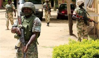 ** FILE ** Soldiers stand guard at the offices of the state-run Nigerian Television Authority in Maiduguri, Nigeria, Thursday, June 6, 2013. Maiduguri is the heart of Nigeria&#39;s Islamic insurgency. (AP Photo/Jon Gambrell)