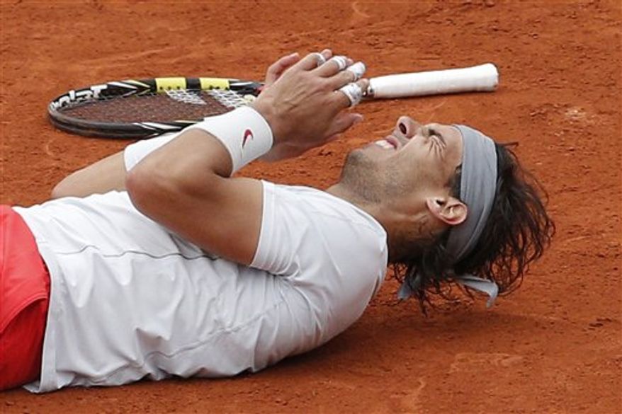 Spain's Rafael Nadal celebrates winning against compatriot David Ferrer in three sets 6-3, 6-2, 6-3, in the final of the French Open tennis tournament, at Roland Garros stadium in Paris, Sunday June 9, 2013. (AP Photo/Christophe Ena)