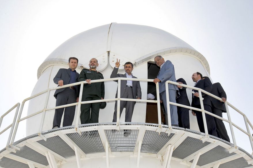 Iranian President Mahmoud Ahmadinejad (third from left) flashes a victory sign during the inauguration of a space tracking center near Delijan, Iran, 125 miles south of Tehran, on Sunday, June 9, 2013. (AP Photo/Fars News Agency, Mahdi Marizad)